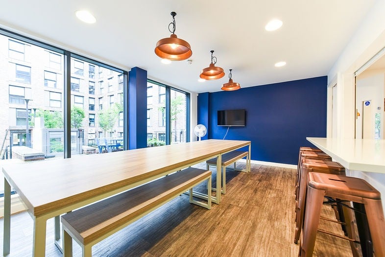 Cafe interior with deep blue walls by Paint and Maintain